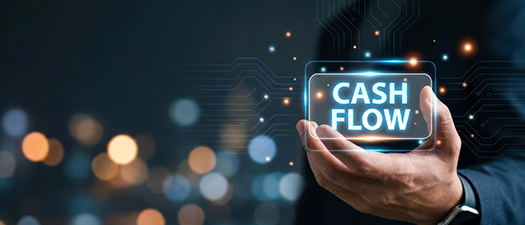 Bildbeschreibung: Ein Schild mit dem Aufdruck „Cashflow“ in der Hand einer Person.